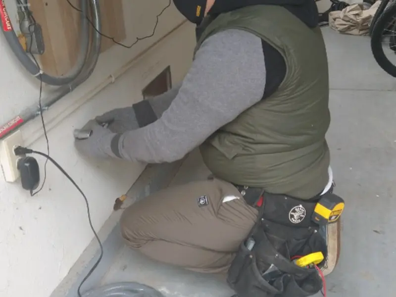 Electrician performing outlet wiring in a Lebanon garage